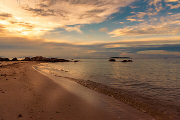 Obraz premium Nature in twilight period which including of sunrise over the sea and the nice beach. Summer beach with blue water and purple sky at the sunset. 