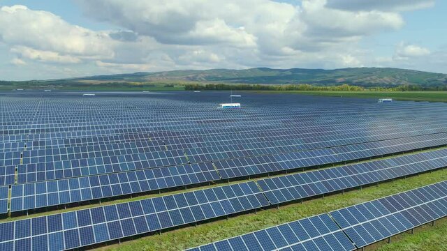 Individual project and professional approach to the organization of the power plant. Solar panels, inverters and components on the farm. Aerial photography. High quality. 4k footage.