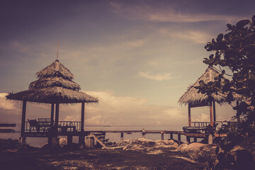 Nature in twilight period which including of sunrise over the sea and the nice beach. Summer beach with blue water and purple sky at the sunset.	

