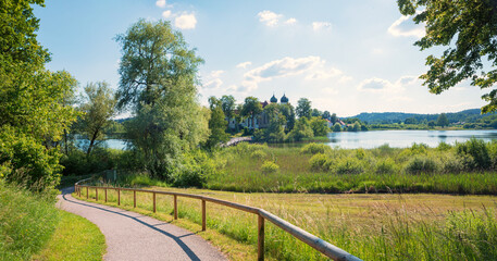 Fototapeta na wymiar walkway around lake Seeon, with beautiful view to the famous cloister