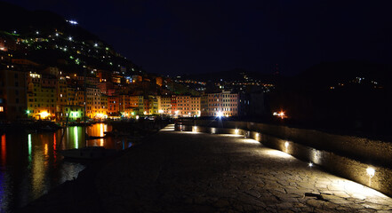 Fototapeta na wymiar incredible view of the small port of Camogli in the evening, lights, colors and reflections on the sea create a magical atmosphere
