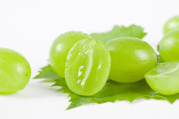 fresh ripe cut green grape isolated on white background.