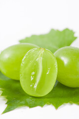 fresh ripe cut green grape isolated on white background.