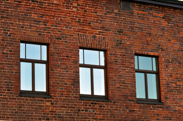 Three windows in a brick wall