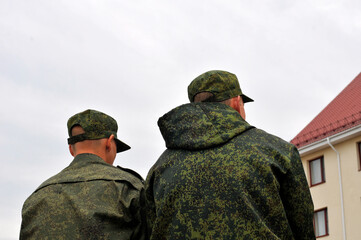 Young military men in camouflage uniforms
