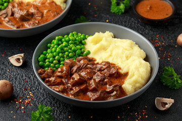 Slow Cooked Steak Diane Casserole with mushroom. mashed potatoes and green peas