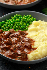 Slow Cooked Steak Diane Casserole with mushroom. mashed potatoes and green peas
