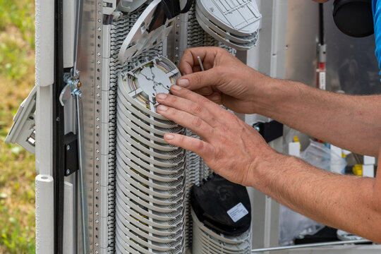 Engineer Connecting Fiber Optic Cable To The Switch