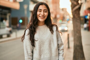 Young middle east girl smiling happy standing at the city.