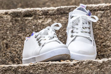 Close-up of sneakers on stone stairs