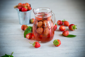 Sweet refreshing berry compote of ripe strawberries in a decanter