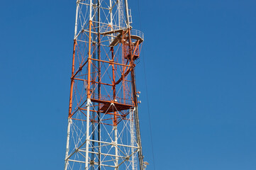 Middle part of the TV tower against the background of the summer blue sky. City of Blagoveshchensk, Russia.