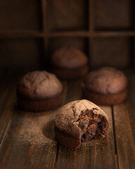 Chocolate homemade cupcakes and one of them is bitten off.