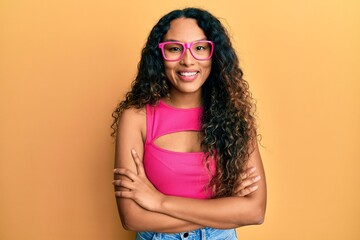 Young latin woman wearing casual clothes and glasses smiling with a happy and cool smile on face. showing teeth.