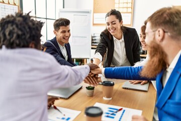 Group of business workers smiling happy celebrating with hands together at the office.