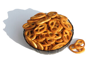 Many small pretzel cookies are on the plate