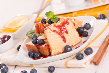 Lemon pund cake with blueberries and strawberry syrup.