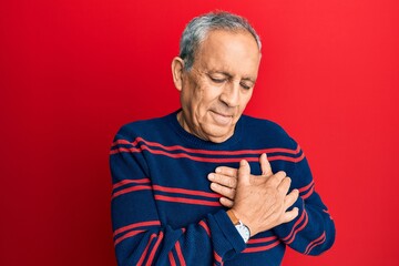 Senior hispanic man wearing casual clothes smiling with hands on chest, eyes closed with grateful...