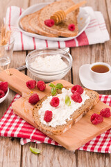 Rye bread with cottage cheese and raspberries.