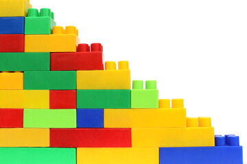 Pyramid assembled from the details of a multicolored bright constructor on a white isolated background