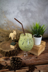Fresh milk green tea menu is placed on a wooden table. The background is a polished wall. beautifully arranged Suitable for making menus - 443234426