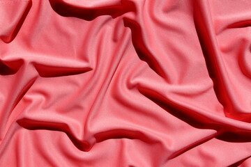 Fabric texture draped on a pink surface
