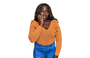 Young african woman wearing casual clothes looking stressed and nervous with hands on mouth biting...