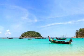 Wooden traditional boat at Kata Beach with crystal clear water, famous tourist destination and resort area, Phuket, Thailand