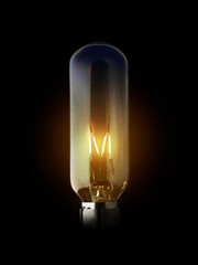 Yellow electric old classic industrial tungsten filament light bulb black background