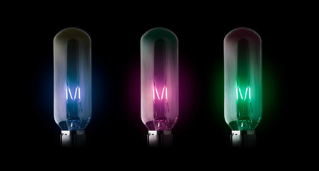 Colorful electric old classic industrial tungsten filament three light bulbs black background