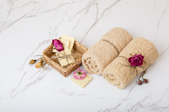 Natural soap with rose flowers. Face care products. Prepare to bath. Spa therapy concept photo. Organic cosmetic on wooden and marble background. Cosmetics for relax and aromatherapy. home hygiene