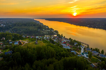 Aerial drone view of ancient russian town Ples on the Volga river with colorful sunset