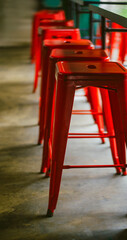 red bar stools in light and shadow