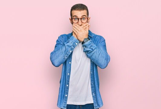 Young caucasian man wearing casual clothes shocked covering mouth with hands for mistake. secret concept.