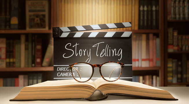 Storytelling concept.Film slate, book, and eyeglasses in the master class.