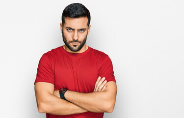 Young hispanic man wearing casual clothes skeptic and nervous, disapproving expression on face with...