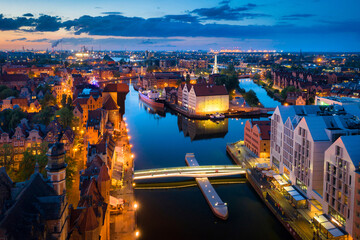 Amazing architecture of the main city in Gdansk at dusk, Poland. Aerial view of the historical Port Crane at the Motlawa river © Patryk Kosmider