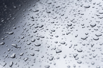 Many different drops of water on the metal surface