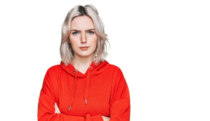 Young blonde girl wearing casual clothes skeptic and nervous, disapproving expression on face with...