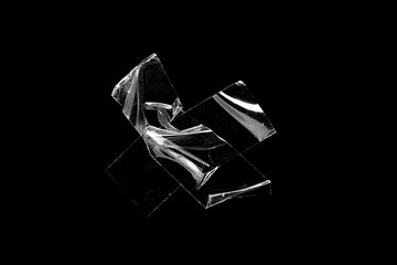 adhesive transparent tape on black background. abstract crumpled sticky tape for poster design...