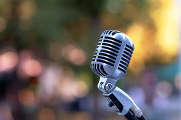 Fototapeta na wymiar Retro style silver microphone on blur background