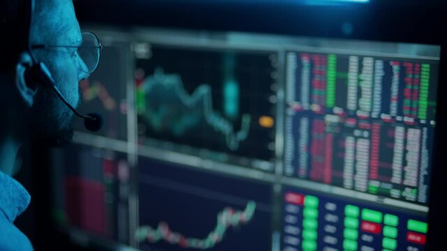 Trader is working with multiple computer screens with charts and data analysis and stock broker trading online. Concept of bitcoin and ethereum blockchain trading. Businessman is checking market data