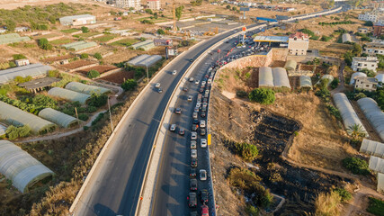 Fototapeta na wymiar Economic crisis: Tens of cars line up near the very few open gas stations in Lebanon