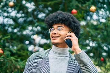 Young african american businessman smiling happy talking on the smartphone at the park.