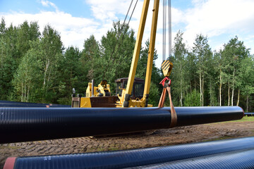 Natural Gas Pipeline Construction. Laying oil pipe in a trench in the ground. Petrochemical industry concept. Refining crude oil