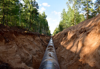 Natural Gas Pipeline Construction. Laying oil pipe in a trench in the ground. Petrochemical...