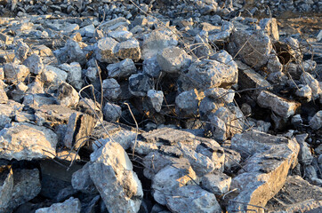 Broken pieces of asphalt. Concrete after crushing for recycling. Reuse crushed concrete rubble, asphalt, building material, blocks and construction waste