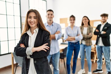 Group of young business workers smiling happy standing with arms crossed gesture at the office.