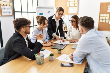 Group of young business workers listening boss speech during meeting at the office.