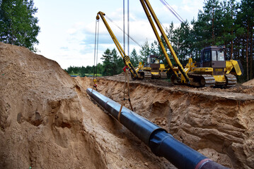Natural Gas Pipeline Construction. Building of transit petrochemical pipe in forest area. Oil...